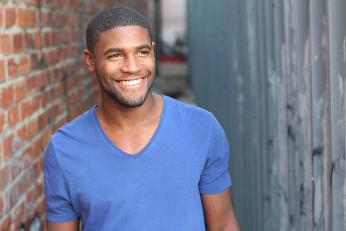 younger african american male in a purple shirt